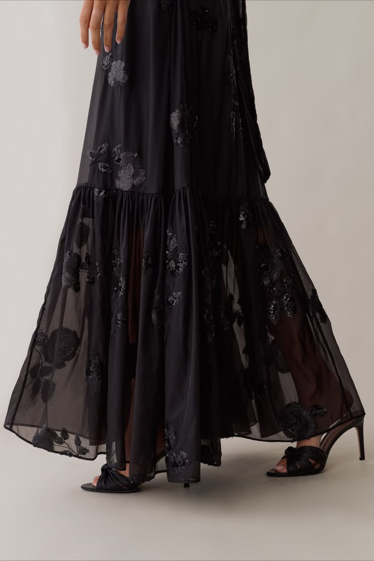The Melody Dress features sheer organza fabric and an inner 